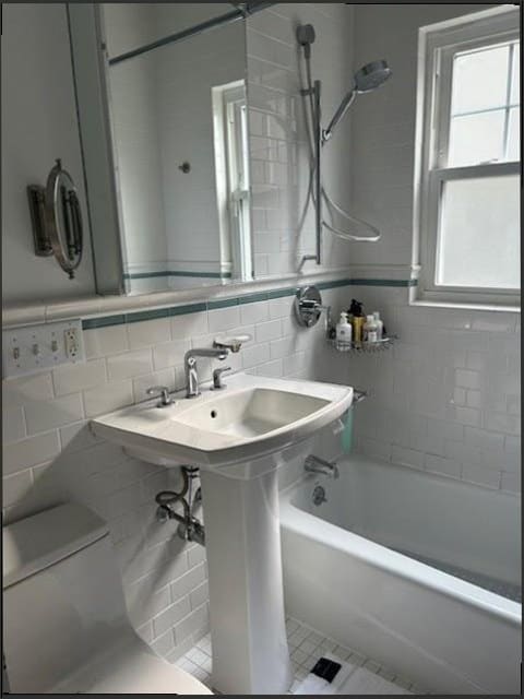 Premium pedestal sink, tub, and shower fixtures installed in a bathroom, the fixture quality expected in Upper Makefield estate homes