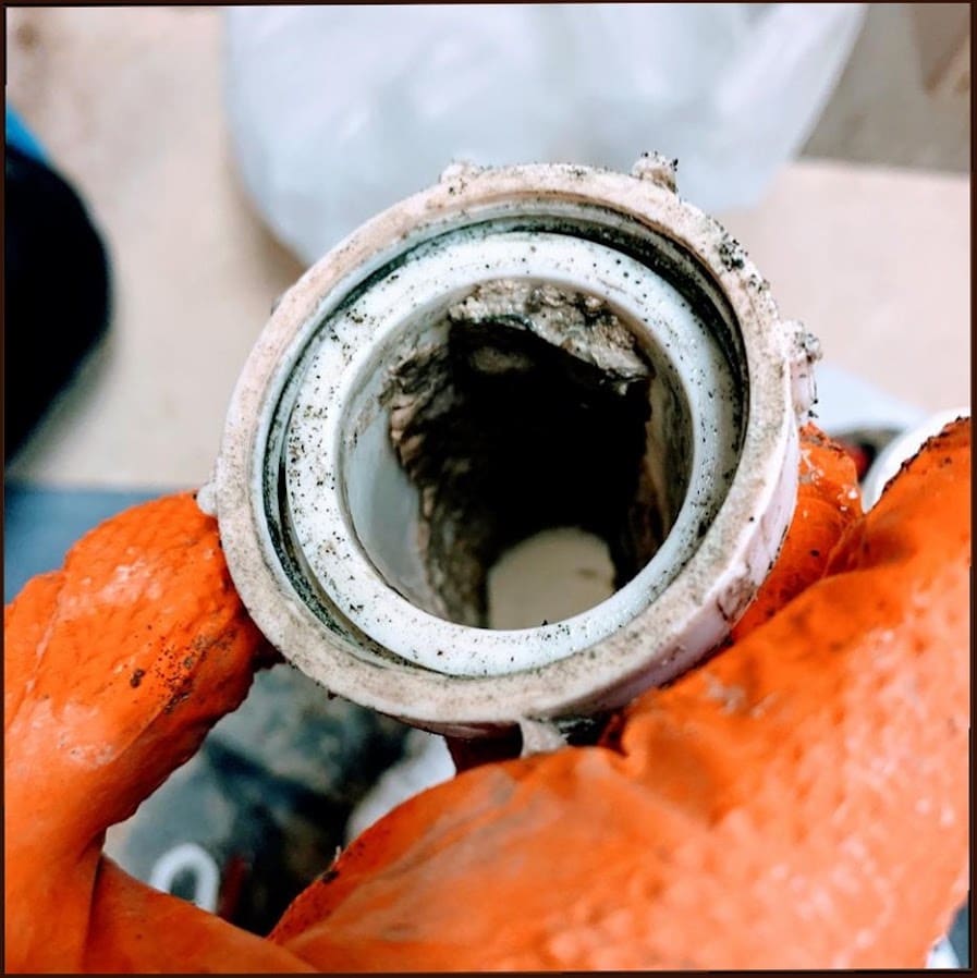 Interior of a heavily corroded and clogged pipe cleared by Duncan Family Plumbing