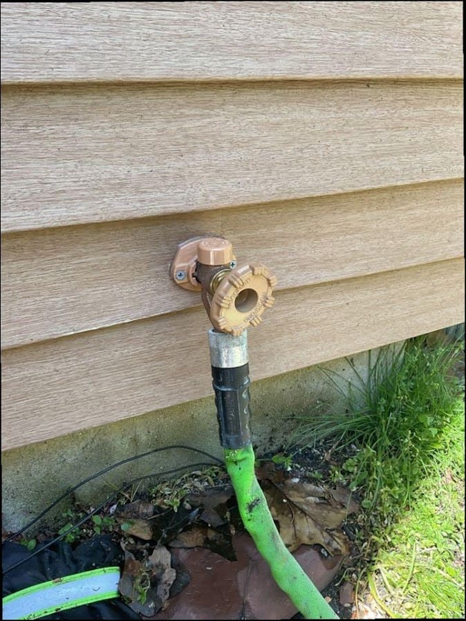 Outdoor hose bib and supply line serviced on a home exterior, common well-adjacent work in rural pockets of Richboro