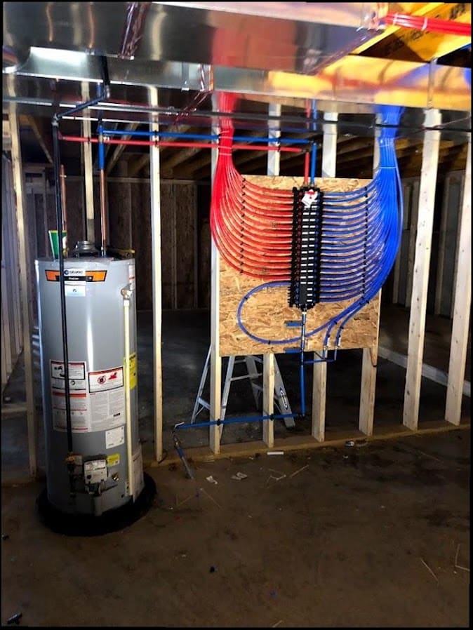 Basement PEX water supply manifold and water heater installed by Duncan Family Plumbing