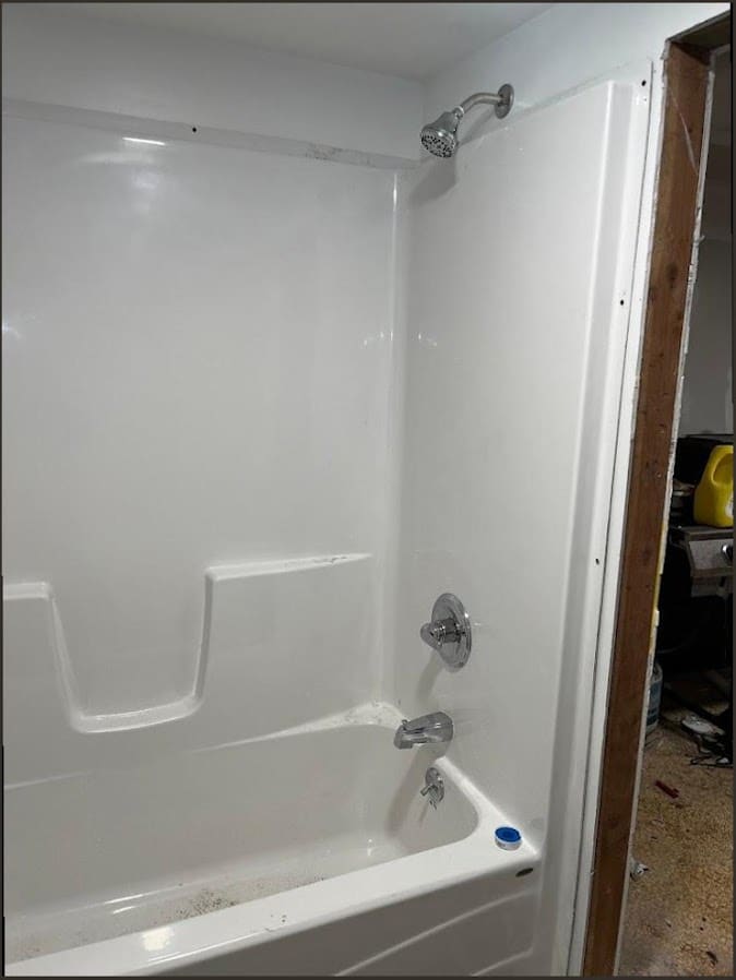 Newly installed tub and shower surround with fixtures, the kind of bathroom fixture work common in Churchville homes