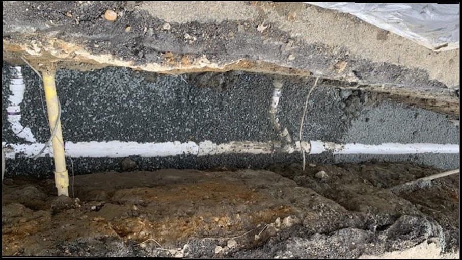 Excavated under-slab drain line insulated and repaired, similar to trenchless sewer work done on aging Washington Crossing infrastructure