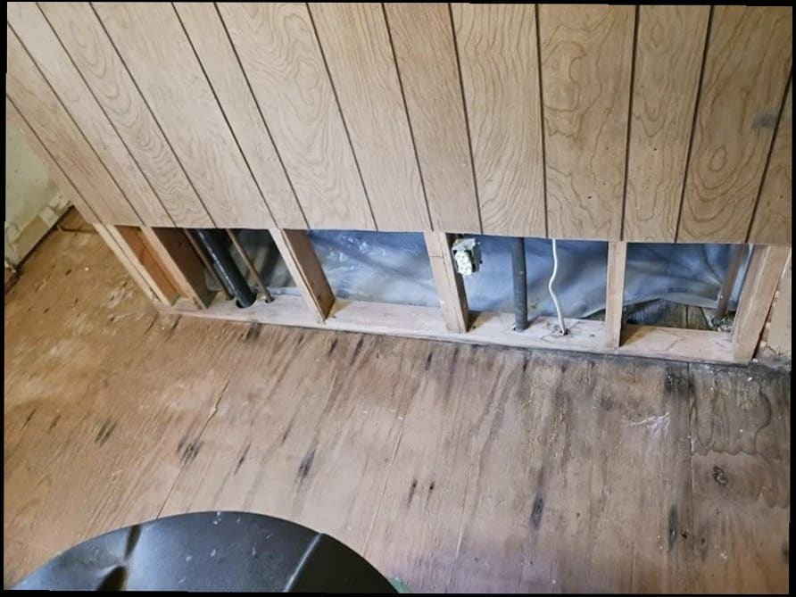 Wall opened to access older galvanized and cast-iron plumbing lines, the kind of hidden-pipe work common in Newtown borough homes